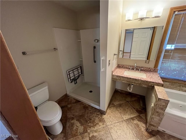 bathroom featuring a garden tub, toilet, a shower, and a sink