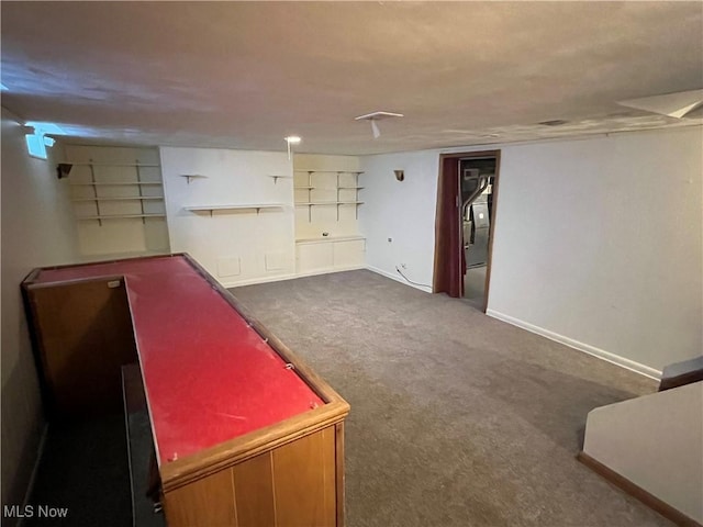 interior space featuring baseboards and carpet