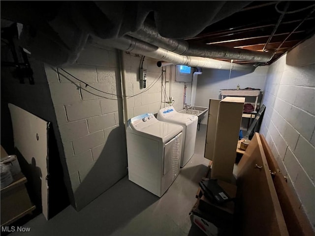 unfinished below grade area with washing machine and clothes dryer