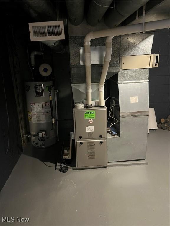 utility room featuring visible vents and water heater