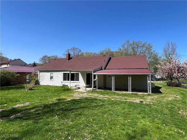 back of property with a lawn and a chimney