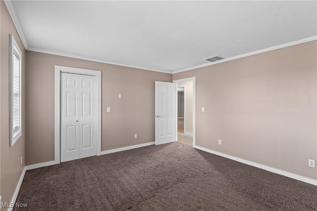 unfurnished bedroom with visible vents, carpet flooring, and crown molding