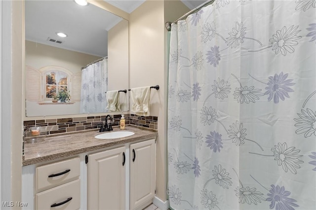 bathroom with visible vents, tasteful backsplash, vanity, and crown molding