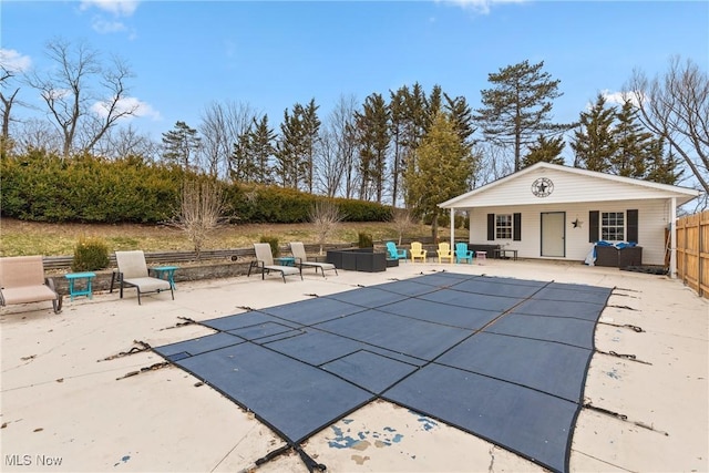 view of swimming pool featuring a patio, a fenced in pool, fence, an exterior structure, and an outdoor structure