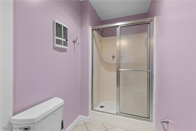 bathroom featuring visible vents, baseboards, toilet, a stall shower, and tile patterned floors