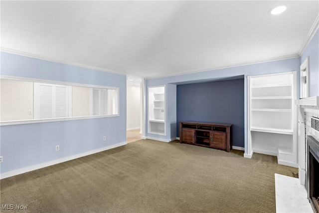 unfurnished living room with built in shelves, carpet, baseboards, a fireplace with flush hearth, and ornamental molding