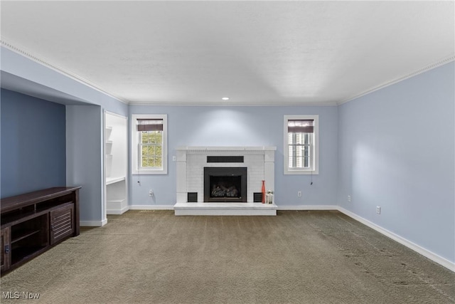 unfurnished living room with baseboards, a fireplace, carpet flooring, and crown molding