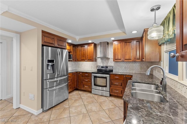 kitchen featuring a sink, tasteful backsplash, appliances with stainless steel finishes, and wall chimney range hood