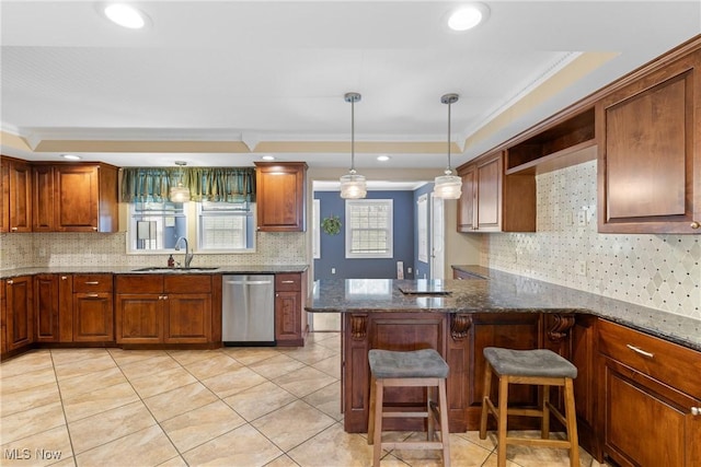 kitchen featuring dishwasher, a raised ceiling, light tile patterned floors, and a sink