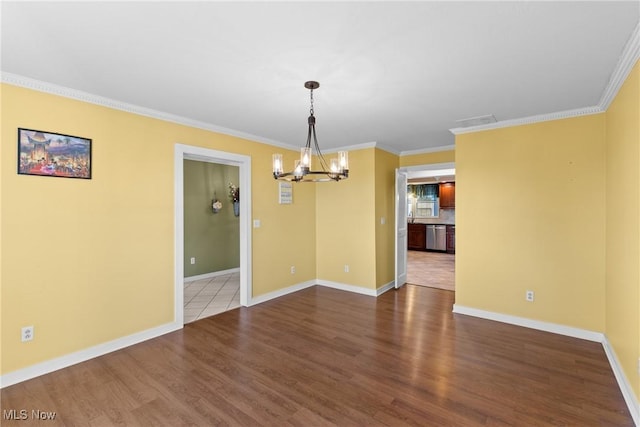 unfurnished dining area featuring ornamental molding, wood finished floors, and a chandelier