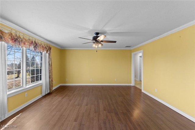 empty room featuring visible vents, crown molding, ceiling fan, baseboards, and wood finished floors