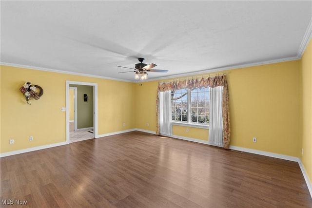 empty room with visible vents, crown molding, ceiling fan, baseboards, and wood finished floors