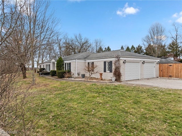 ranch-style home with gravel driveway, a front lawn, an attached garage, and brick siding