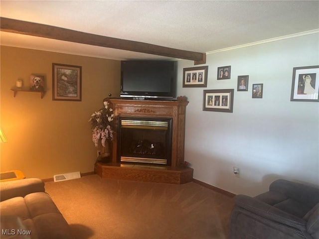 living area featuring beam ceiling, a glass covered fireplace, baseboards, and carpet floors