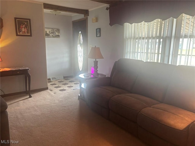 living area featuring visible vents, baseboards, and carpet flooring