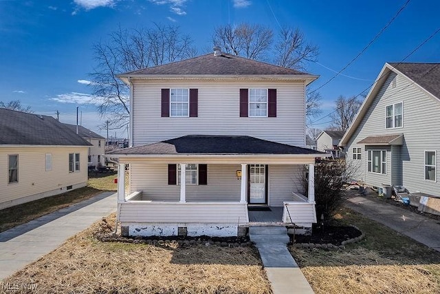 traditional style home with covered porch and roof with shingles