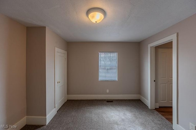 unfurnished bedroom featuring baseboards and carpet flooring