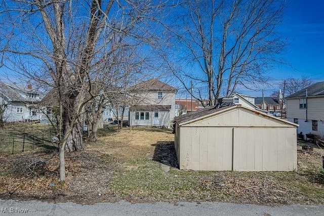 view of yard featuring a storage unit and an outbuilding