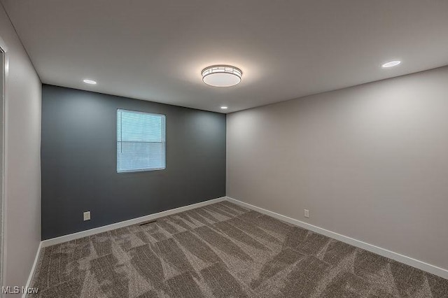 spare room featuring carpet flooring, recessed lighting, and baseboards