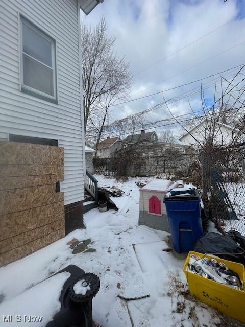 yard covered in snow with fence