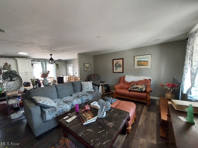 living area with baseboards and wood finished floors