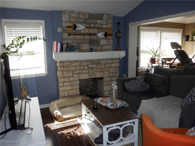 living area with a fireplace and vaulted ceiling