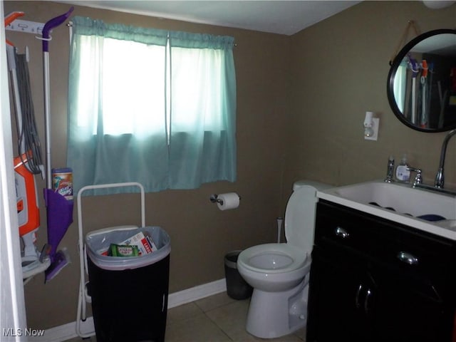 bathroom featuring tile patterned flooring, toilet, vanity, and baseboards