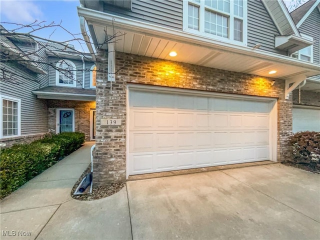 garage featuring concrete driveway