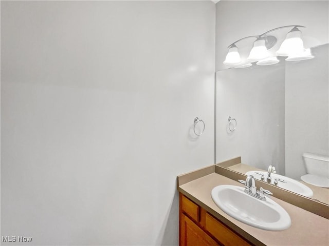 bathroom featuring toilet and vanity