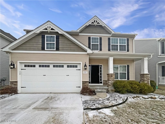 craftsman house featuring stone siding and concrete driveway