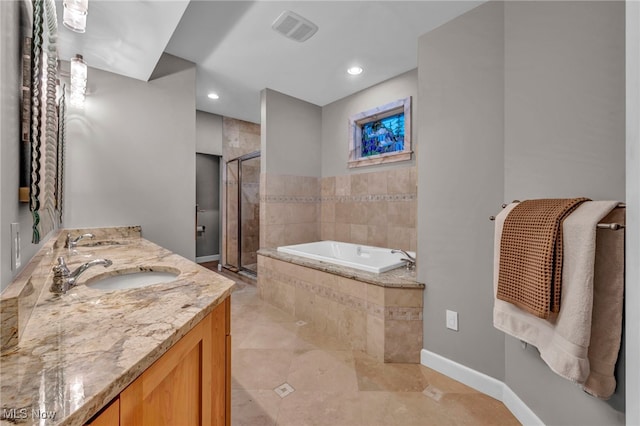 full bathroom with visible vents, a shower stall, a garden tub, and a sink