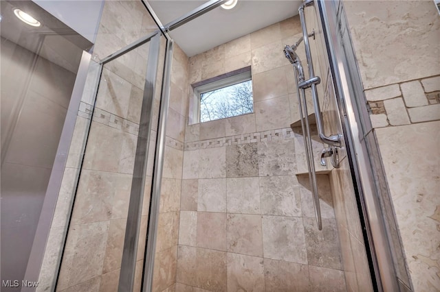 full bathroom featuring recessed lighting and a shower stall