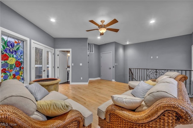 living area featuring wood finished floors, recessed lighting, french doors, baseboards, and ceiling fan