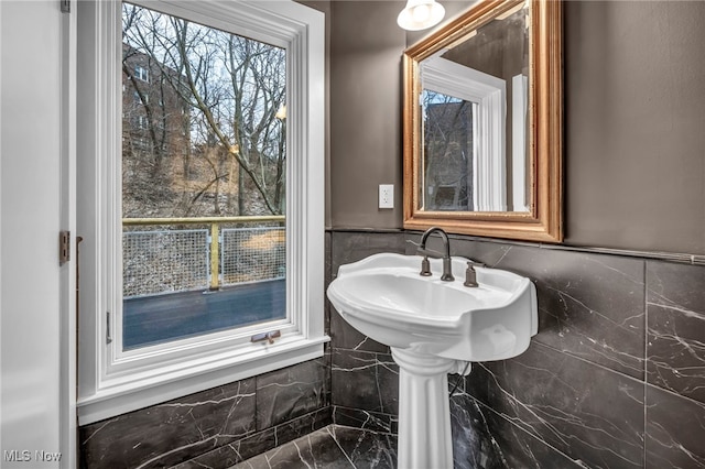 bathroom featuring tile walls and wainscoting