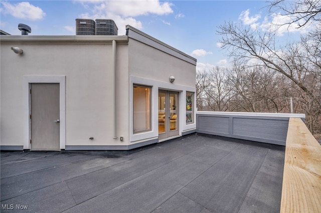 exterior space with a patio, central AC unit, french doors, and stucco siding