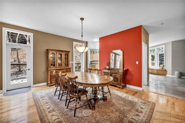 dining room with baseboards and light wood-style floors