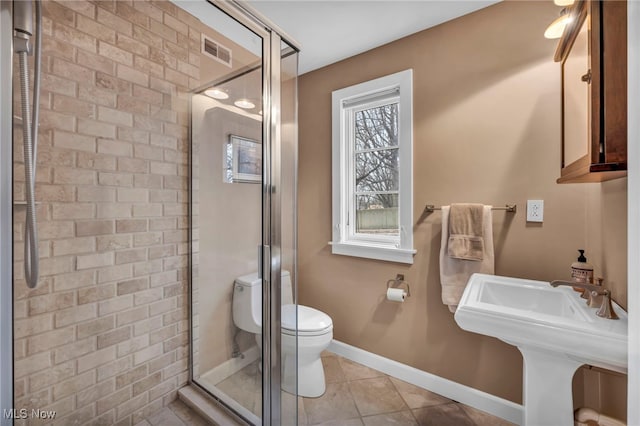 full bathroom featuring tile patterned flooring, visible vents, a shower stall, baseboards, and toilet