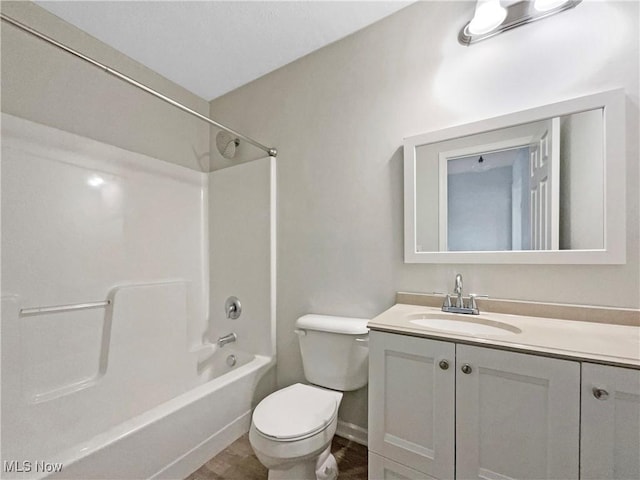 full bathroom featuring baseboards, toilet, vanity, and  shower combination