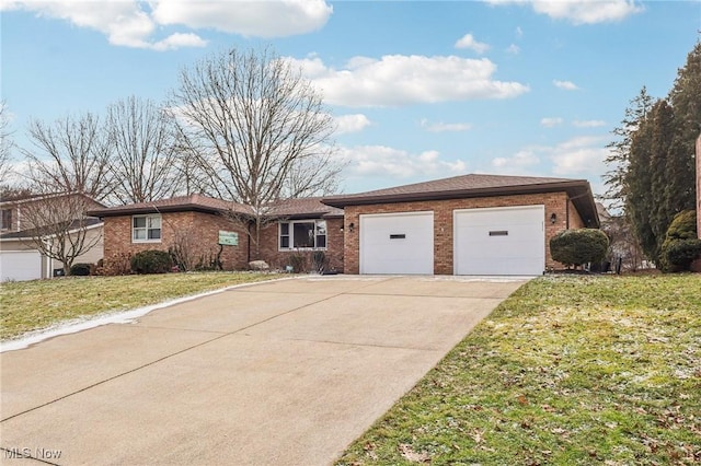 single story home featuring a front yard, an attached garage, brick siding, and driveway