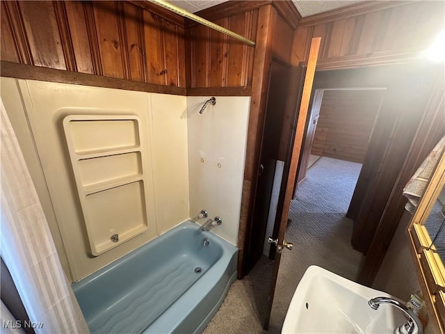 bathroom featuring  shower combination and wooden walls