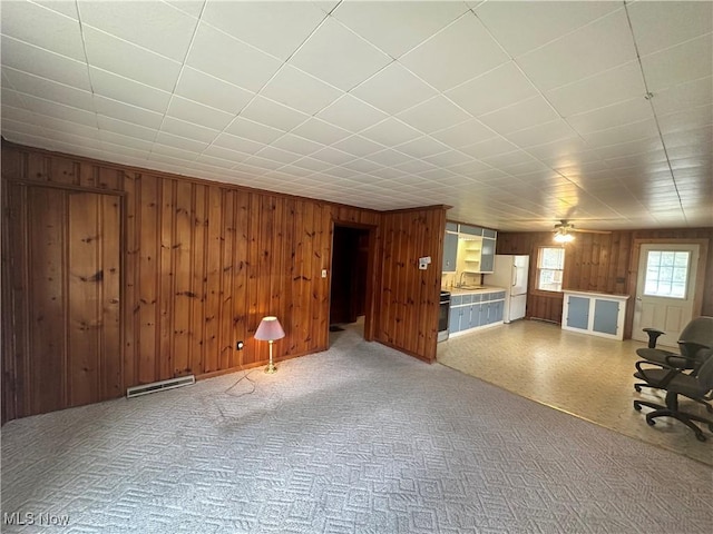 unfurnished living room featuring visible vents and wood walls