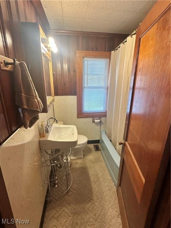 full bathroom with toilet, shower / bath combo, and a sink