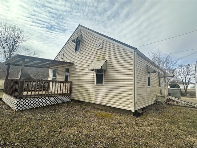 rear view of property featuring a deck