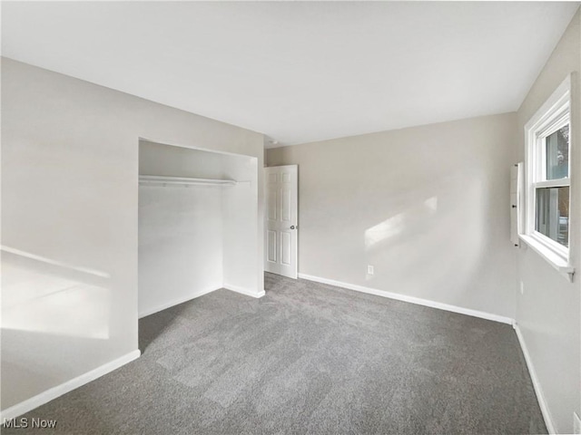 unfurnished bedroom with carpet, baseboards, and a closet