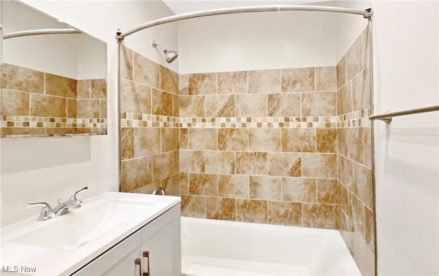 bathroom featuring vanity and  shower combination