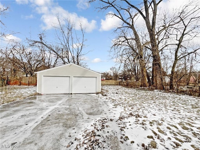 snow covered garage featuring a garage