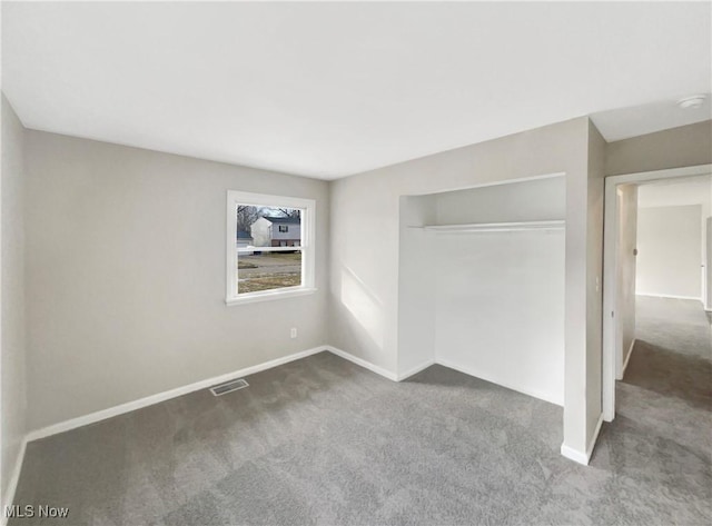 unfurnished bedroom featuring a closet, baseboards, visible vents, and carpet floors