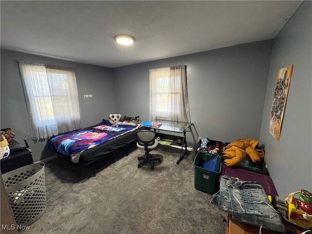 bedroom with multiple windows and carpet