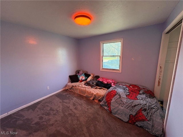 bedroom with baseboards and carpet