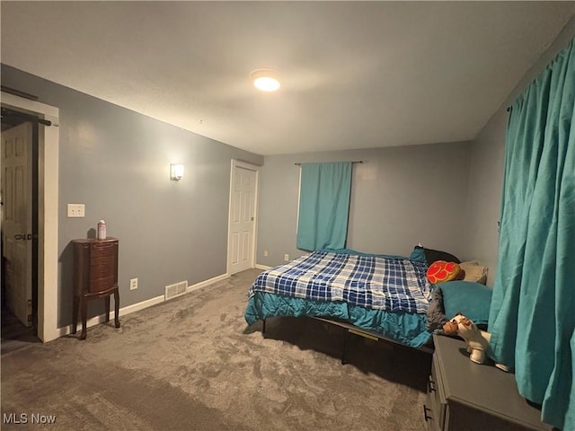 bedroom featuring visible vents, carpet floors, and baseboards